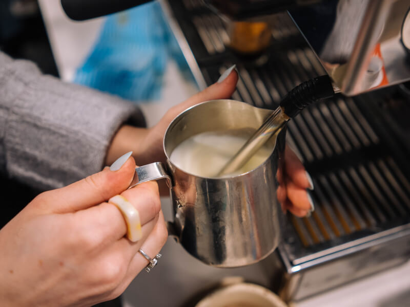 steaming milk at espresso machine